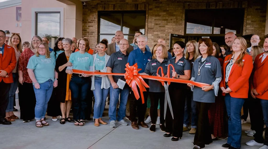 Rapha International team at a ribbon-cutting celebration
